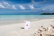 © Nida - Pristine beach with clear turquoise waters, Ace of Hearts card in sand