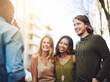 © SunriseDon/peopleimages.com - Talking, smile and friends in city together for community, bonding or tourism for weekend break. Chat, outdoor and group of happy people in urban town or street for adventure, holiday or vacation
