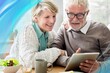 © Rawpixel.com - Happy senior couple using tablet remix