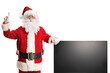 © Ljupco Smokovski - Santa claus leaning on a tv screen and pointing up