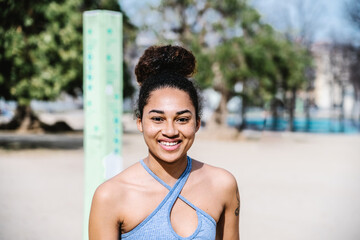 Smiling Woman in Athletic Wear Outdoors on a Sunny Day