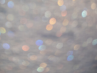 Wall Mural - Artistic, shiny, purposely blurred background with white and colorful bokeh effect of snow in sunlight