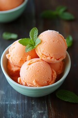 Wall Mural - Melon Sorbet Scoops with Fresh Mint in Bowl. Cantaloupe-mint Sorbet