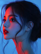 © Daniil - A young Korean woman poses under vibrant blue and red lighting, showcasing her elegant profile in a stylish artistic setting