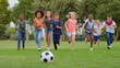 © Monkey Business - Group Of Children Playing Football With Friends In Park
