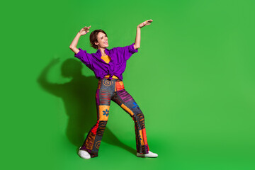 Wall Mural - Photo of crazy young woman wear trend vintage garment and bob haircut takes part in dance battle isolated on green color background