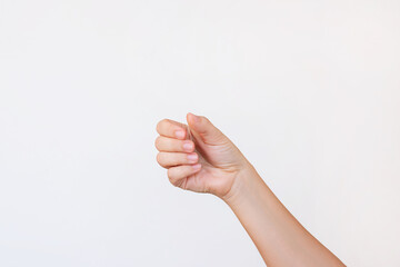 a fist-shaped female hand with clenched closed fingers making a gesture like holding something isola