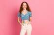 © deagreez - Cheerful young woman in floral top against pink background