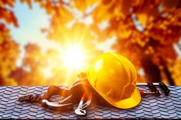 Yellow engineering helmet at sunset, at construction site