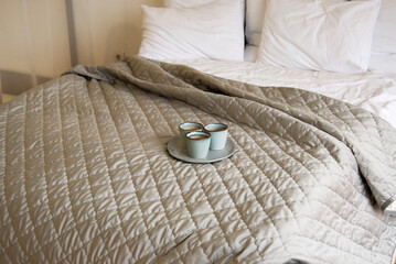 beige interior of bedroom with two blue cups. Beige tone. Coziness conception	