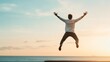 © fotofabrika - A person leaps joyfully against a sunset backdrop at the beach, capturing a moment of freedom and exhilaration just before twilight