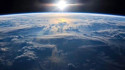 Wall Mural - a breathtaking view of earth from space, with the sun rising over the horizon and casting a golden g