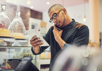 Fototapete - Businessman, waiter and multitasking with phone call or tablet for order, online enquiry or purchase at coffee shop. Man, employee or barista with mobile smartphone or technology for service at cafe