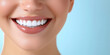 © Maksym - The joyful, bright smile of a woman showing her perfect white teeth, with a softly blurred blue gradient in the background, evoking feelings of confidence and beauty.
