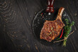 © Надія Коваль - rib eye Tomahawk beef veal steak on a dark background. top view. copy space for text