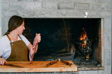 Wall Mural - Smiling woman preparing to cook a barbecue