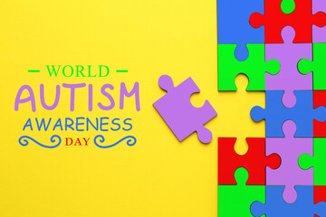 Sticker - World Autism Awareness Day text and colorful puzzle pieces on yellow background, top view