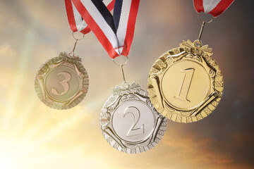 Canvas Print - Gold, silver and bronze medals against sky at sunset