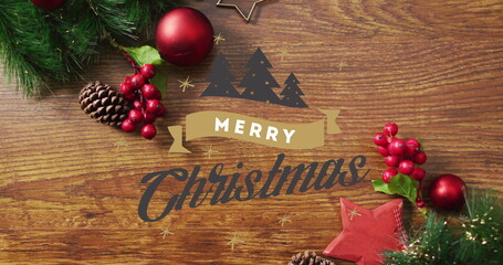 Sticker - Image of merry christmas text over christmas decorations on wooden background