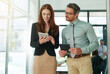 © ThurstanJam/peopleimages.com - Business, collaboration or tablet with man and woman in office together for planning. Conversation, feedback and teamwork with happy corporate people in professional workplace for online research