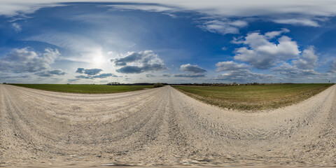 Wall Mural - spherical 360 hdri panorama on roadside of gravel road with clear clouds in thunderstorm front dark 