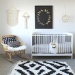 © Woranuch - Modern Nursery Interior with Black and White Decor and a Wicker Rocking Chair.