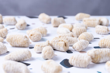 Counter full of raw gnocchi in preparation.