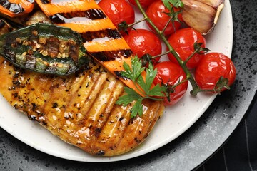 Delicious grilled vegetables and chicken breast on table, top view