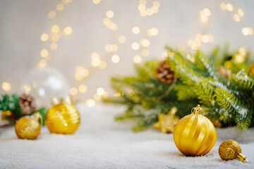 Wall Mural - christmas holiday background with snow, fir tree and decorations with christmas light behind. christ