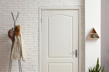 Sticker - Metal rack with jacket and cap in hallway