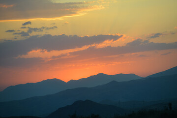 Beautiful sunset over the mountains in the summer.