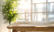 © escapejaja - Rustic wooden table with greenery and soft sunlight creating a bright and inviting space