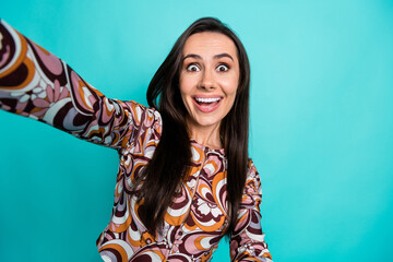 Wall Mural - Photo of cheerful impressed lady dressed retro shirt taking selfie empty space isolated blue color background