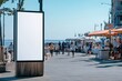 © gankevstock - Blank billboard on bustling boardwalk by the sea on a sunny day