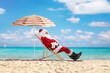 © Ljupco Smokovski - Santa claus sitting on a sun lounger