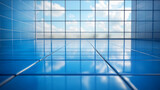 Blue tile floor with glass wall view of sky.
