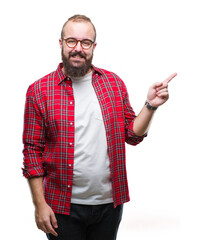 Wall Mural - Young caucasian hipster man wearing glasses over isolated background with a big smile on face, pointing with hand and finger to the side looking at the camera.