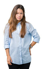 Wall Mural - Young beautiful brunette business woman over isolated background skeptic and nervous, frowning upset because of problem. Negative person.