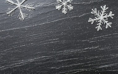 Poster - snowflakes delicately resting on a dark textured surface during a winter season afternoon