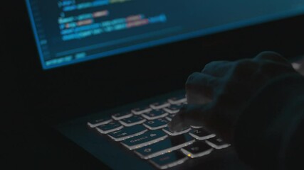 Programmer's hands and laptop keyboard close-up