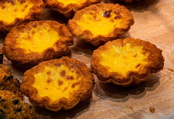 Freshly baked egg tarts with golden crusts.