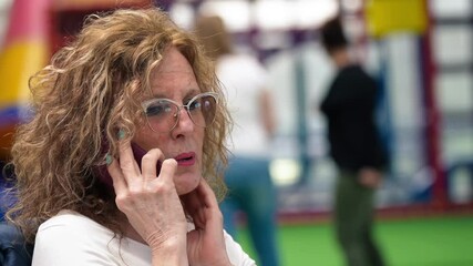 Poster - a woman talking at the smartphone at home
