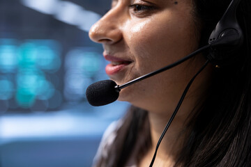 Poster - expert in data center call center talking in headset microphone, providing logistics support. close 