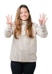 Wall Mural - Young beautiful brunette woman wearing turtleneck sweater over isolated background showing and pointing up with fingers number eight while smiling confident and happy.