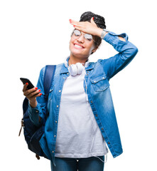 Wall Mural - Young braided hair african american student girl using smartphone over isolated background stressed with hand on head, shocked with shame and surprise face, angry and frustrated. Fear and upset.