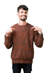 Wall Mural - Young handsome man wearing winter sweater over isolated background looking confident with smile on face, pointing oneself with fingers proud and happy.