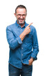 © Krakenimages.com - Middle age hoary senior man wearing glasses over isolated background cheerful with a smile of face pointing with hand and finger up to the side with happy and natural expression on face.