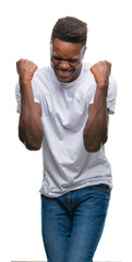 Wall Mural - Young african american man over isolated background very happy and excited doing winner gesture with arms raised, smiling and screaming for success. Celebration concept.