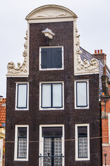 Wall Mural - Colorful old buildings with gable rooftops and hooks along Herengracht canal. In XVII century richest merchants, most influential regents and mayors lived on this canal. Amsterdam, the Netherlands.