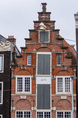 Wall Mural - Colorful old buildings with gable rooftops and hooks along Herengracht canal. In XVII century richest merchants, most influential regents and mayors lived on this canal. Amsterdam, the Netherlands.